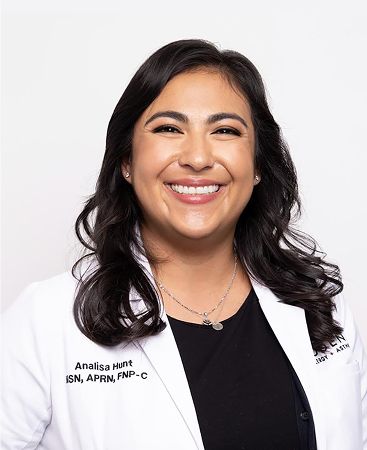 Smiling healthcare professional in lab coat.