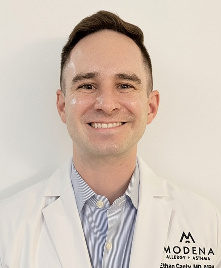 Smiling doctor in a white lab coat.