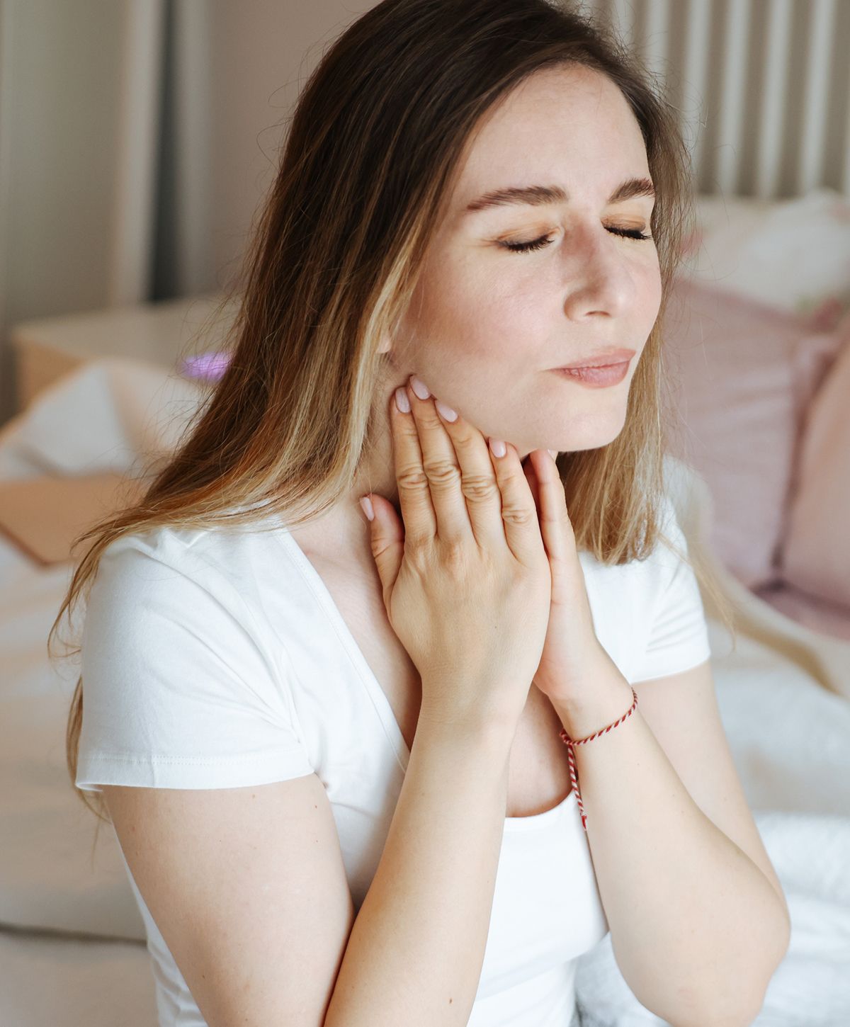 Woman relaxing with hands on her neck.