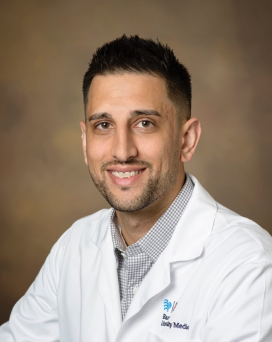 Smiling healthcare professional in lab coat.