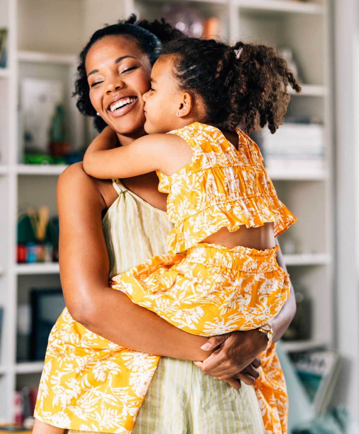Mother and daughter sharing a joyful embrace.