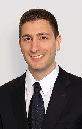 Professional man in suit smiling for portrait.