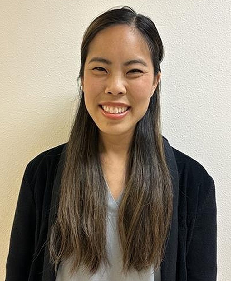 Smiling man in a suit on a white background.