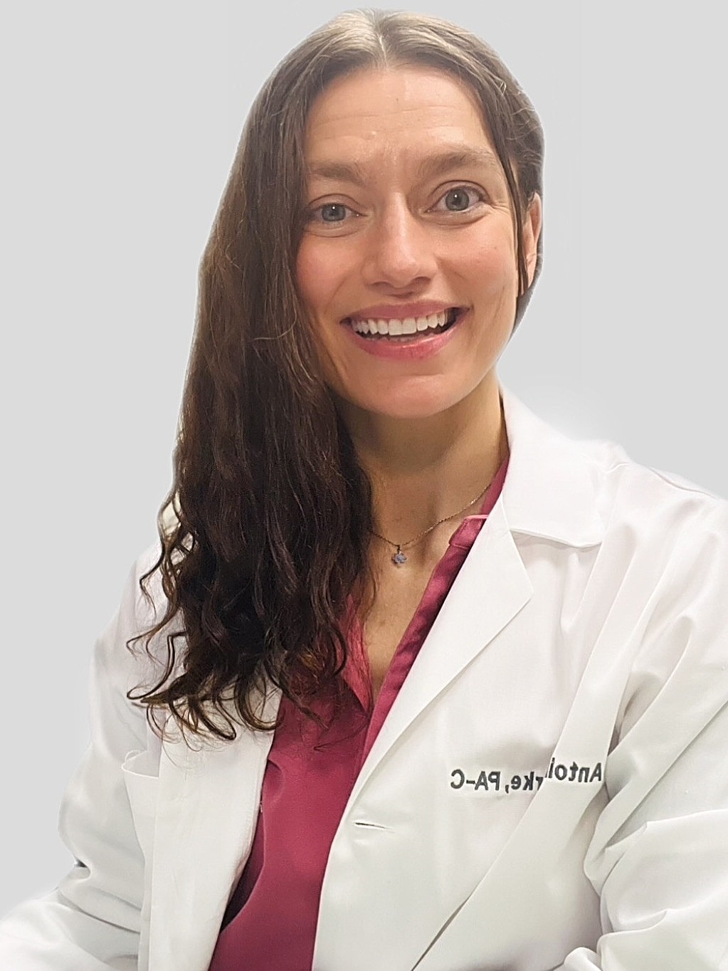 Antoinette Burke, PA-C, RD in white coat smiling modena health
