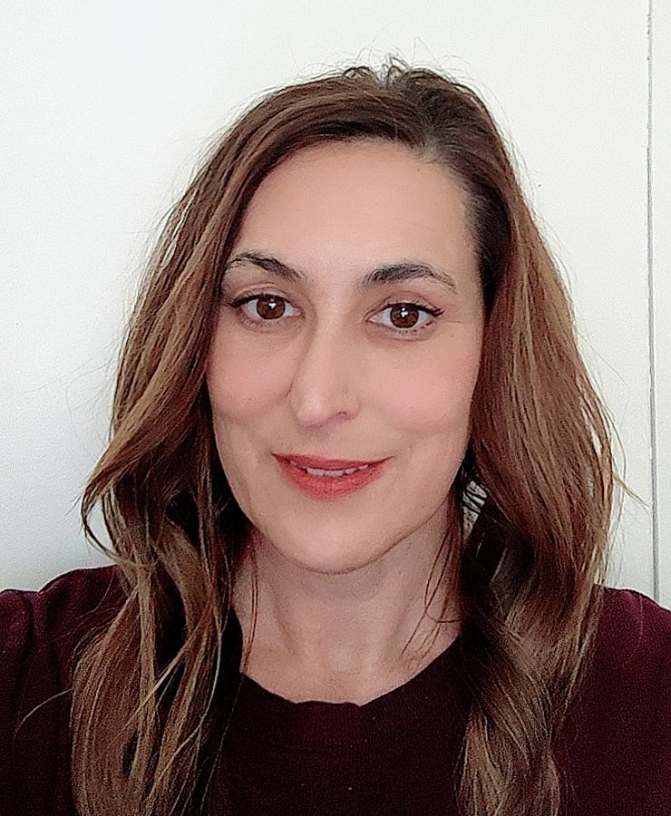 Smiling man in a suit on a white background.