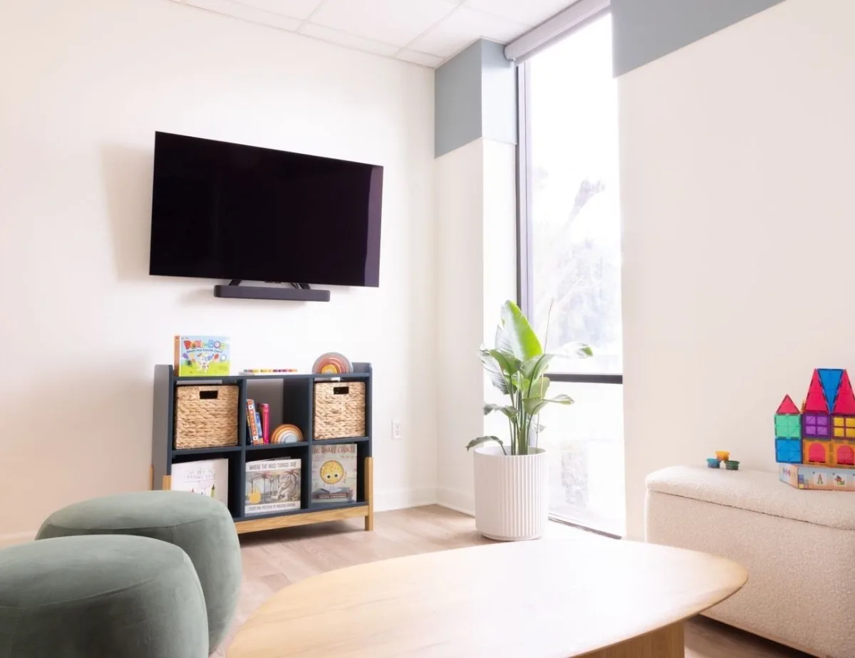 Cozy playroom with TV and colorful toys.