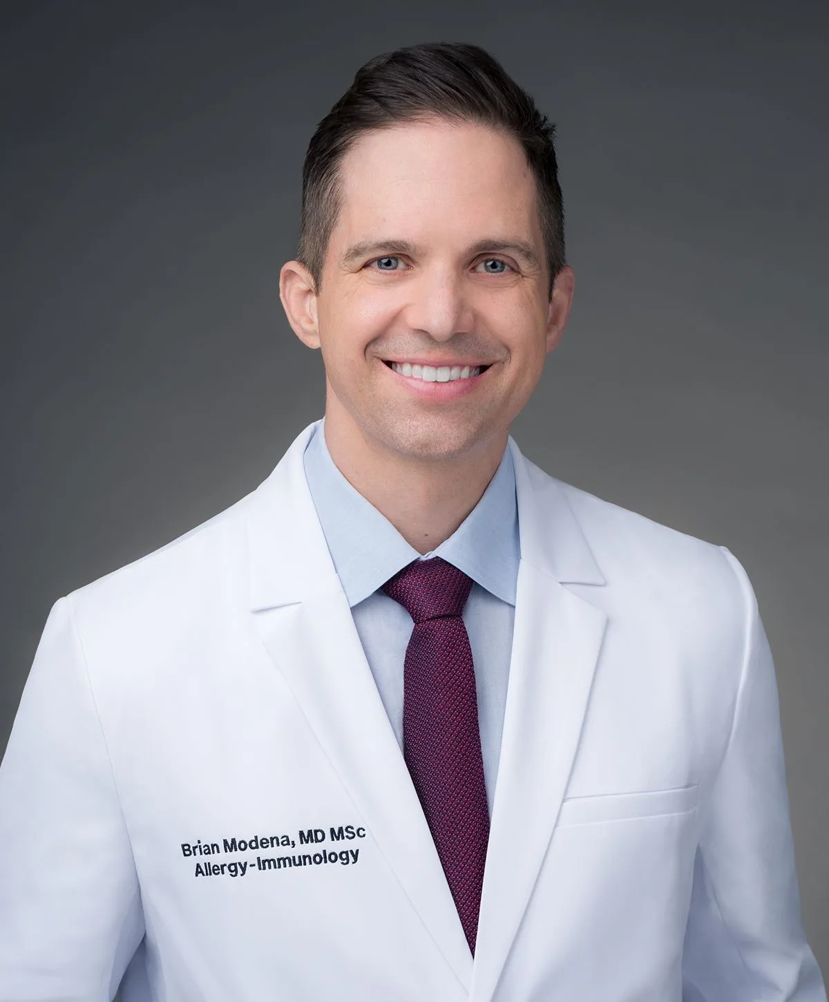 Portrait of doctor in white coat smiling