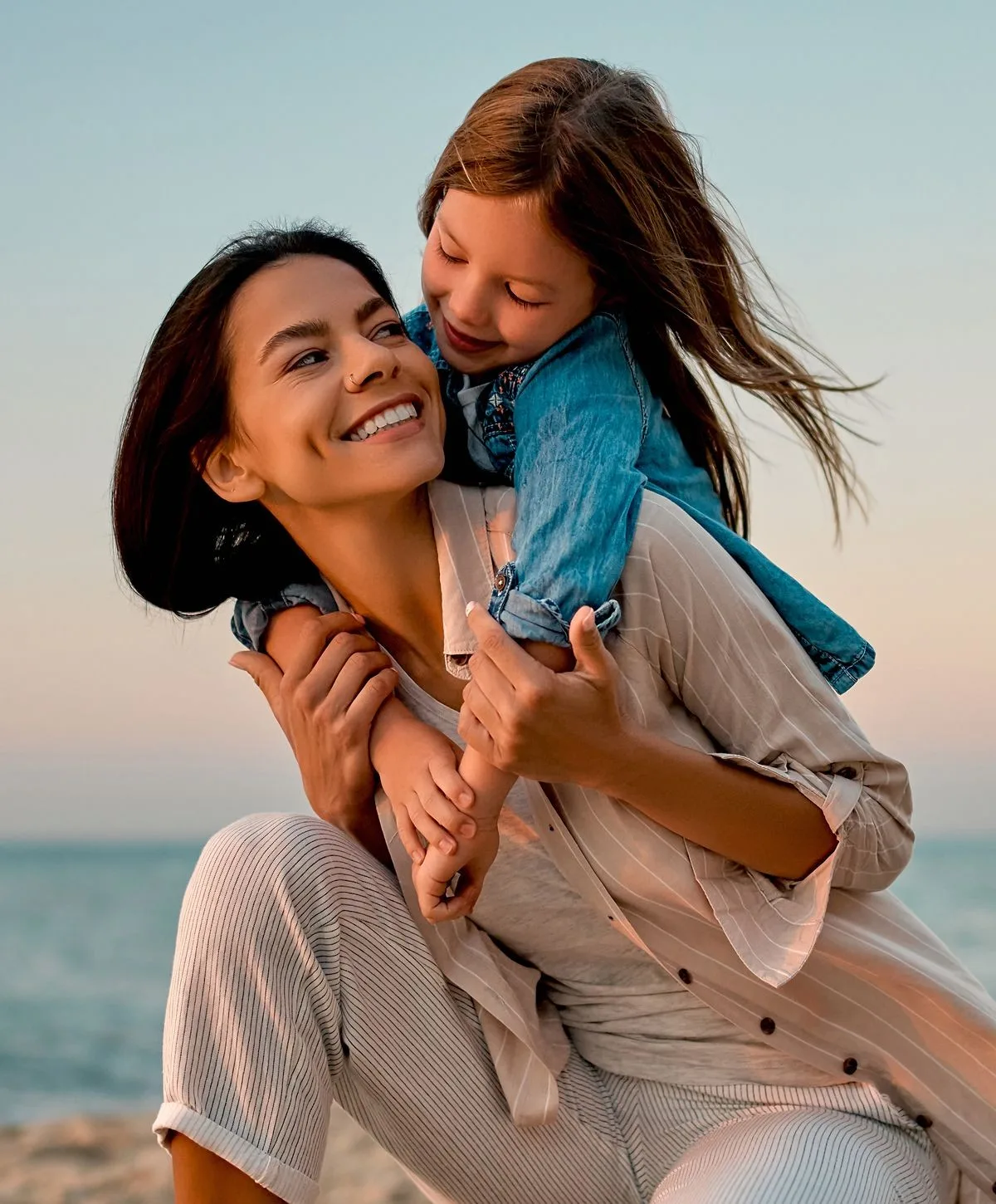 Mother and daughter enjoying a beach moment.