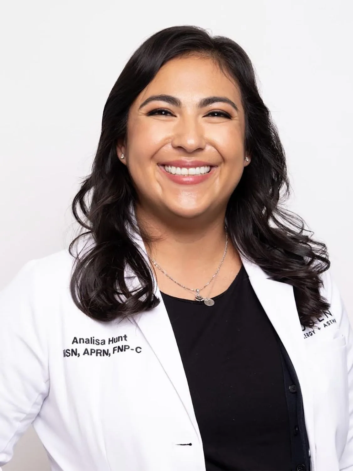 Smiling healthcare professional in a white coat.