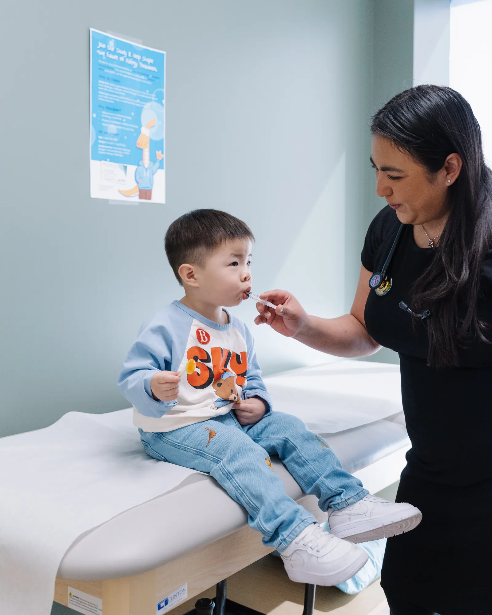 Child receiving an oral immunotherapy dose from a Modena Health clinician.