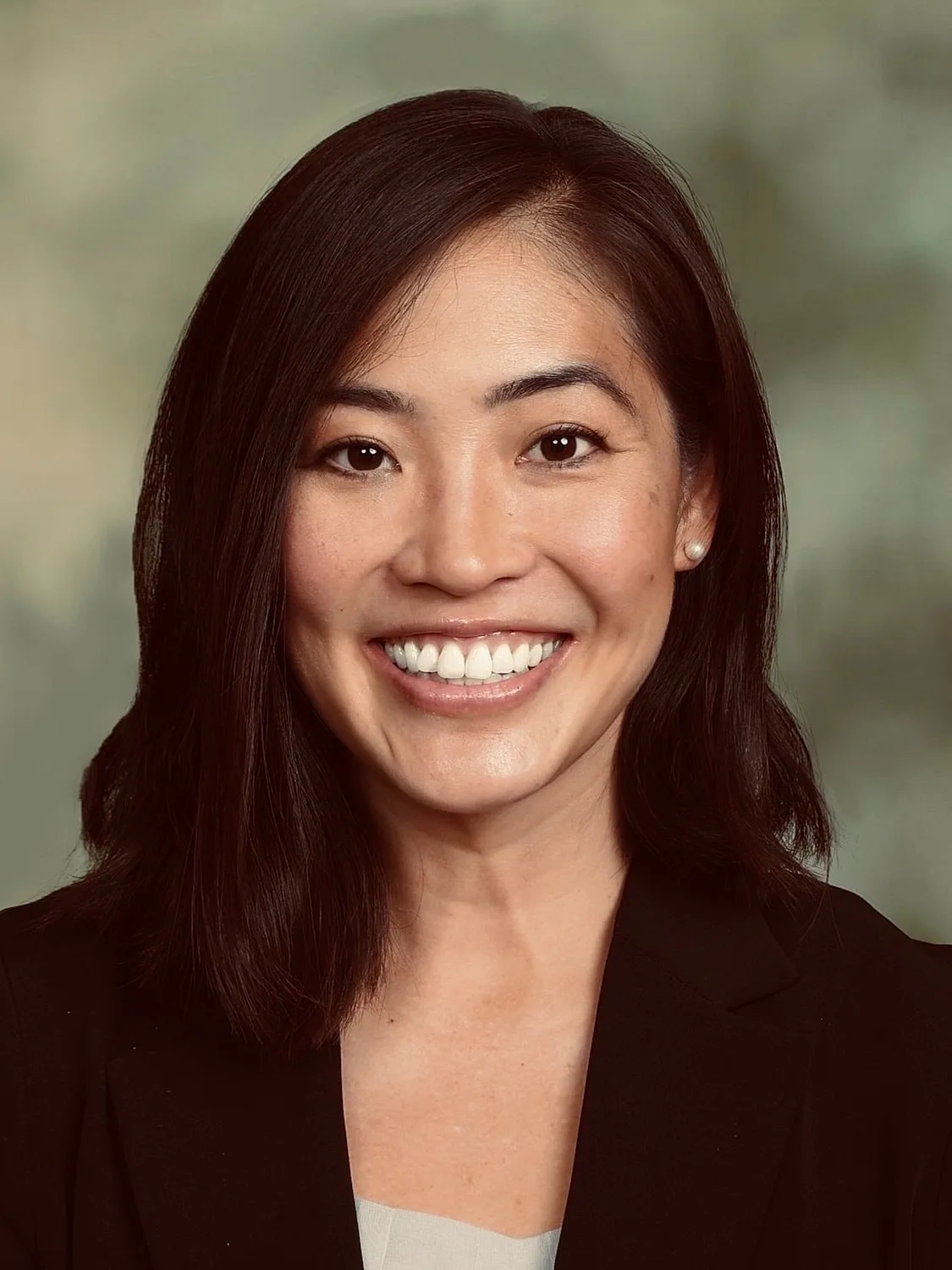Smiling woman in professional attire.