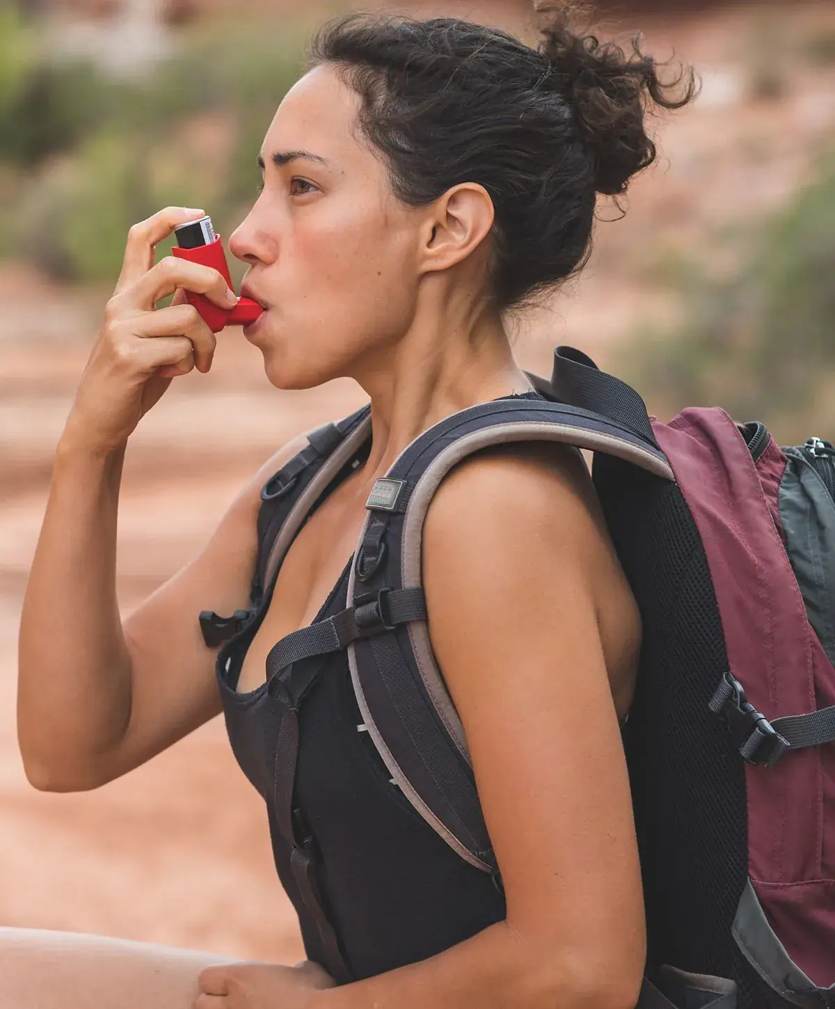 Woman using breathing care plans while hiking outdoors.