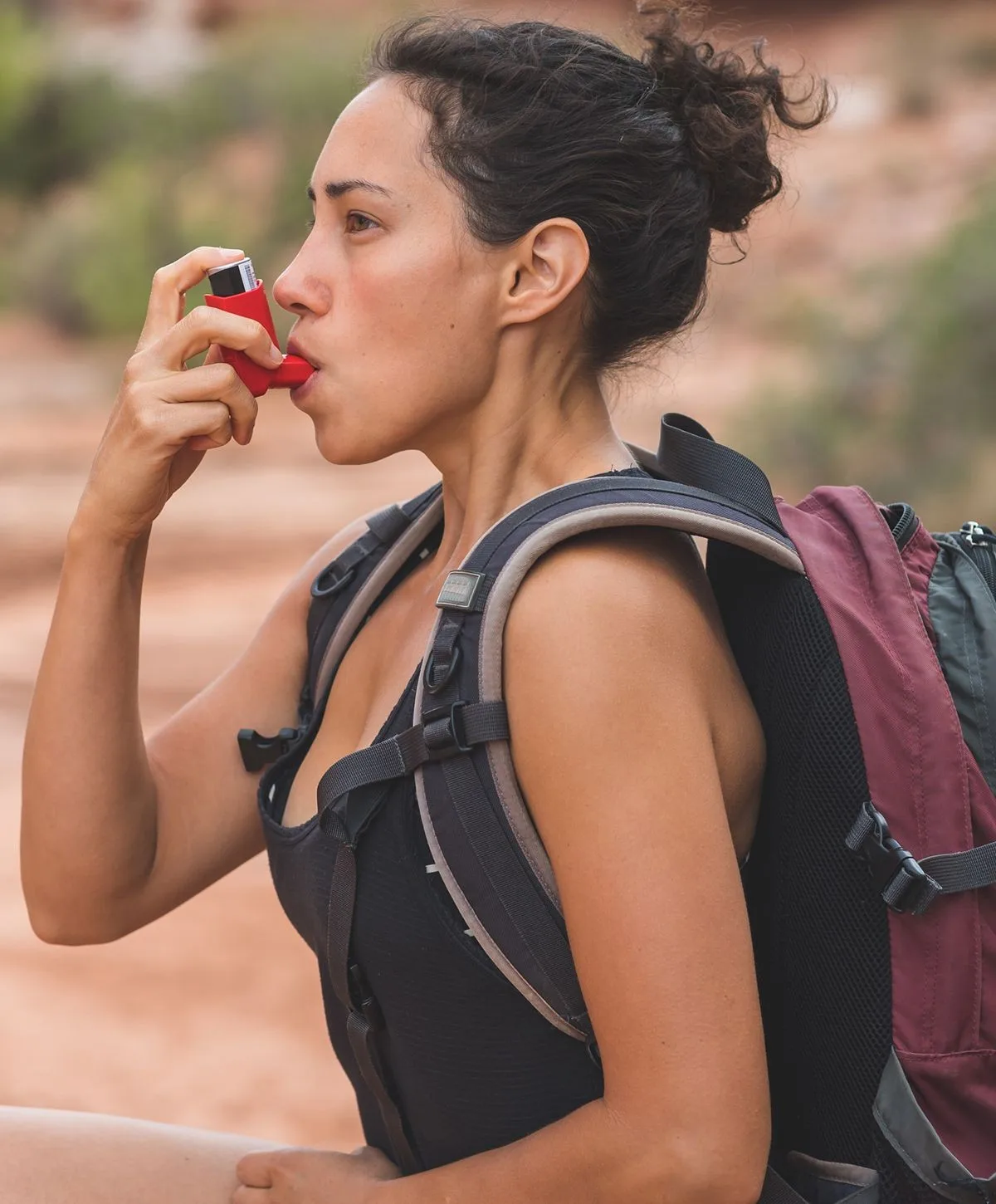 Woman using breathing care plans while hiking outdoors.