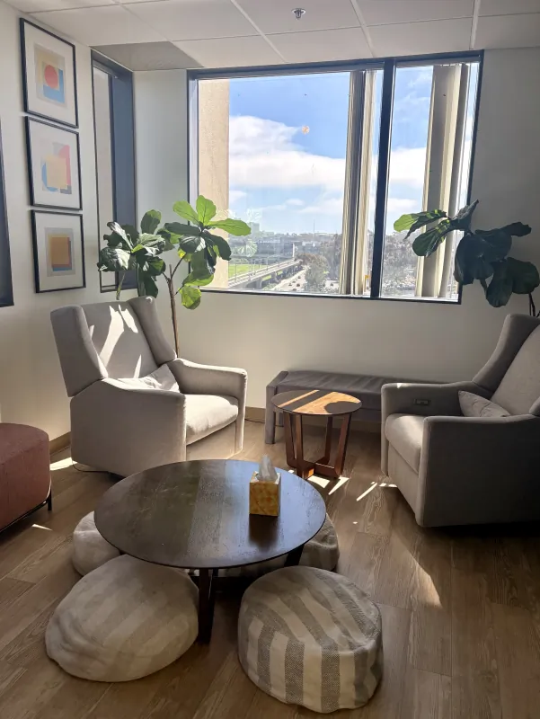 Waiting lounge with window seating at the Modena Health La Jolla office.