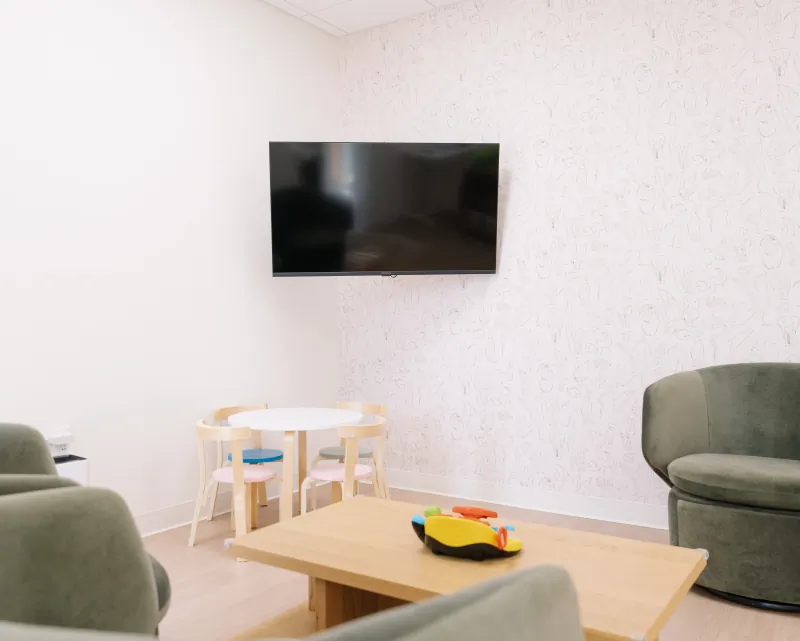 Child-friendly lounge seating and a play table at the Modena Health Solana Beach office.