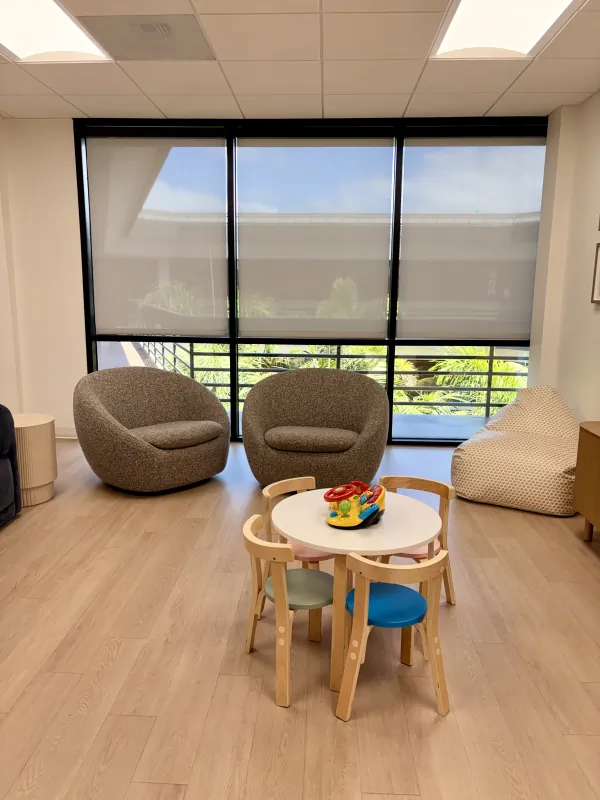 Child-friendly waiting area with large windows at the Modena Health Solana Beach office.