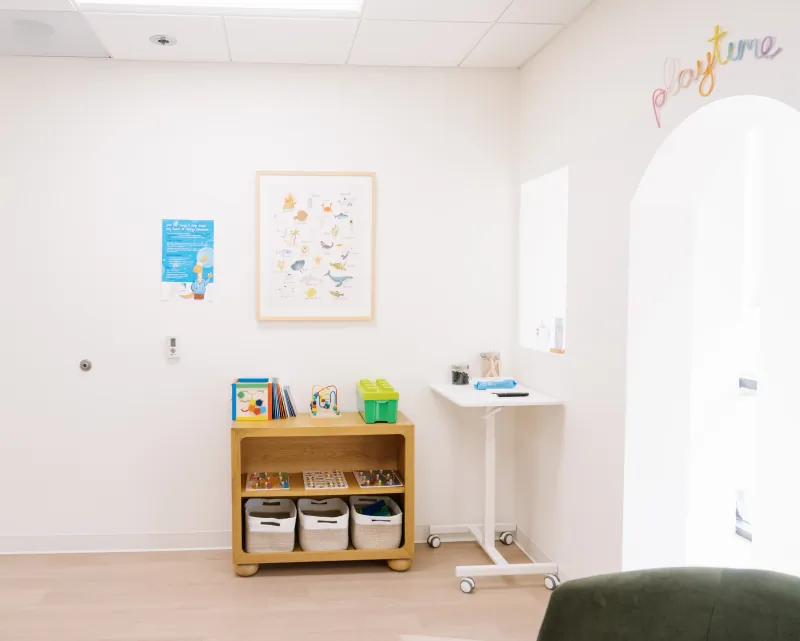 Books, toys, and activity shelves in the children's area at the Solana Beach office.