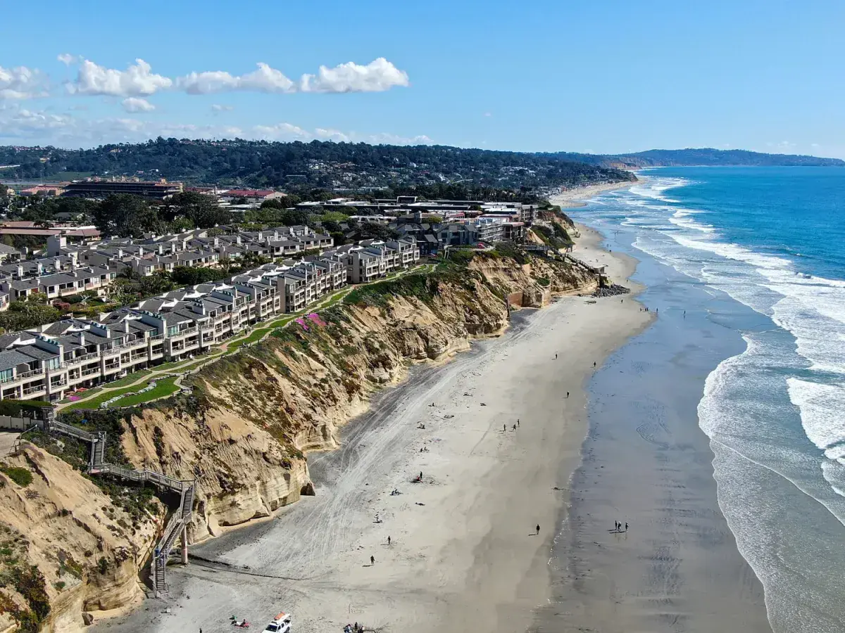Coastal view with cliffs and sandy beach.