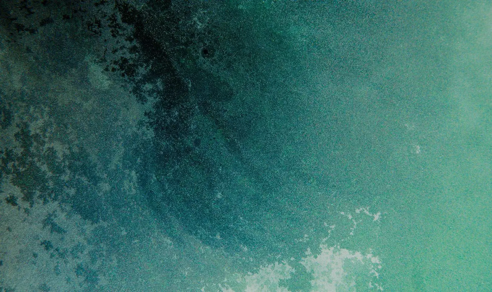 Abstract teal and blue textured background image.