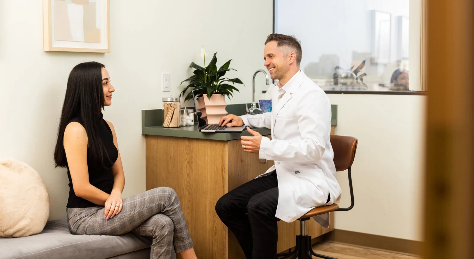 Patient consults with a doctor in an office.
