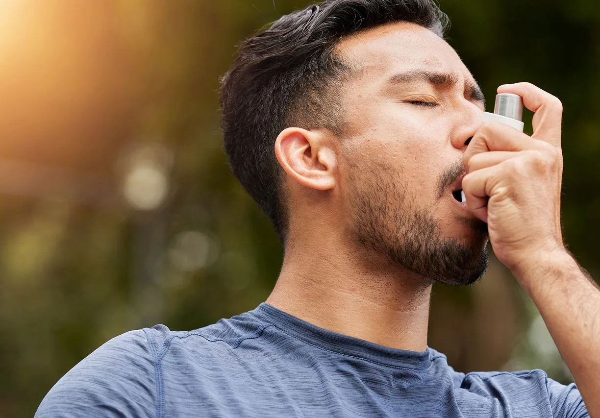 Man using asthma breathing care plans outdoors.