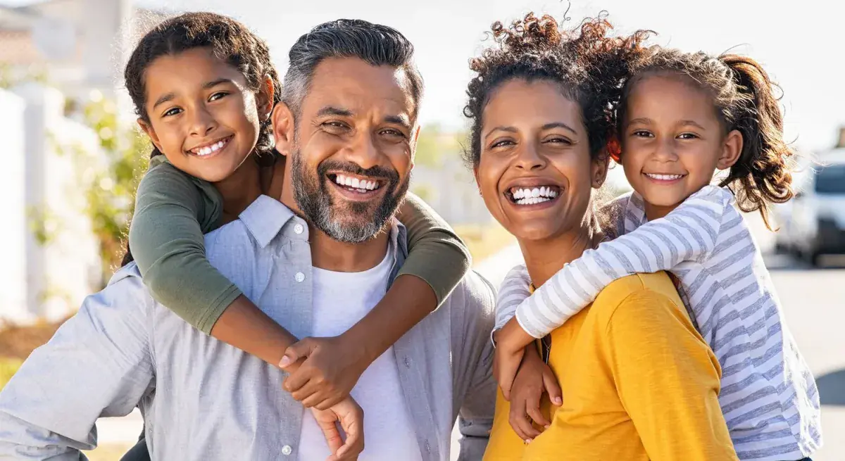 Happy family smiling outdoors together.