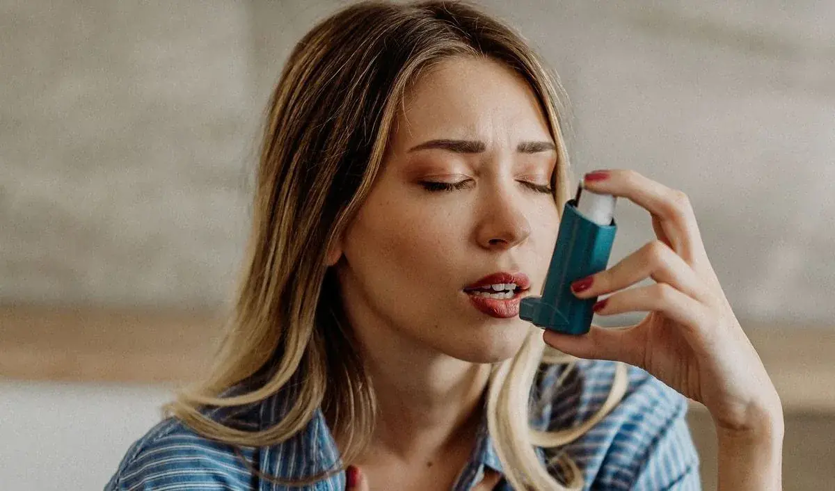 Patient using a prescribed asthma inhaler.